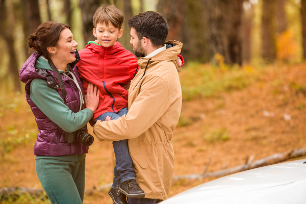 happy family near car in forest