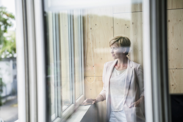 businesswoman looking out of window