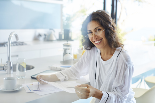 portrait smiling businesswoman in bathrobe reviewing
