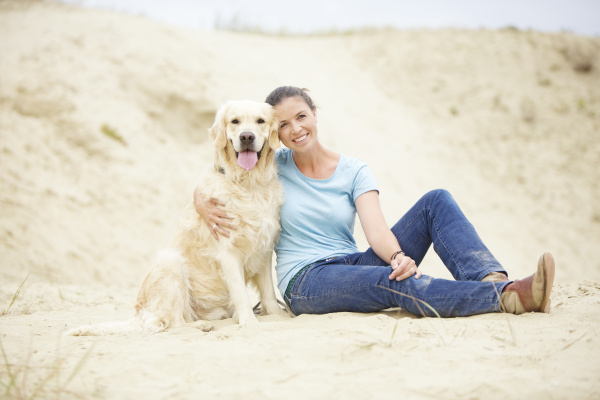 smiling young woman with dog in