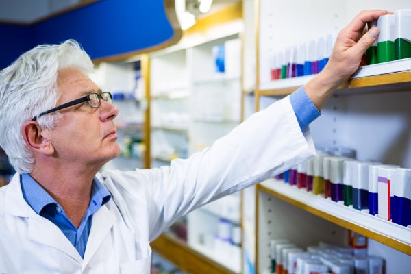 pharmacist checking medicines in pharmacy