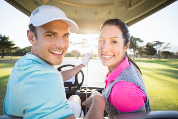 cheerful golfer couple sitting in golf