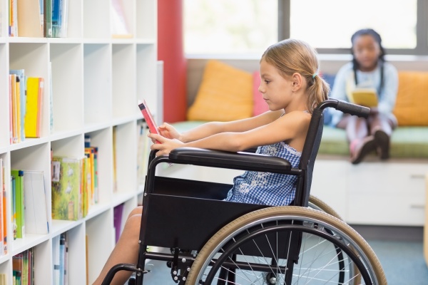 disabled school girl selecting a book