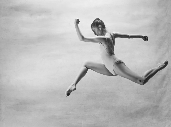 young beautiful modern style dancer jumping