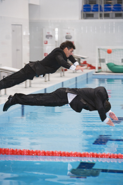 businessmen jumping in pool