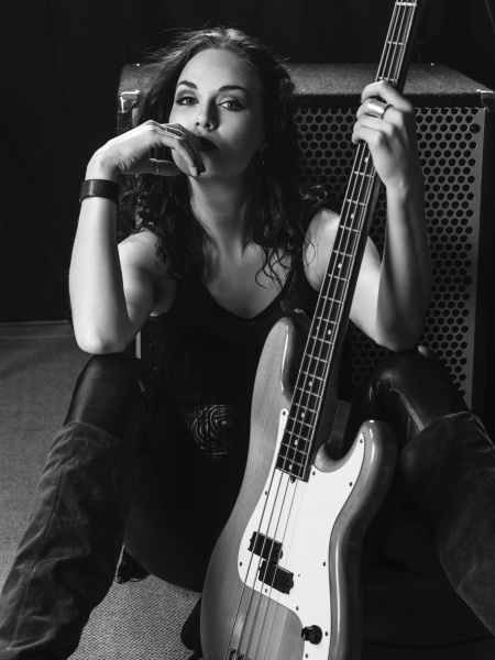 Beautiful bass player sitting with her guitar - Stock Photo #21354673 ...