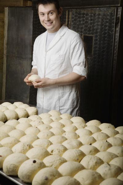 baker with balls of bread dough