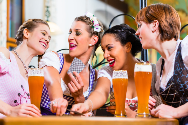 women in bavarian pub playing cards