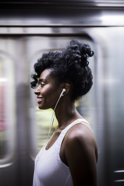 profile of smiling woman with earphones