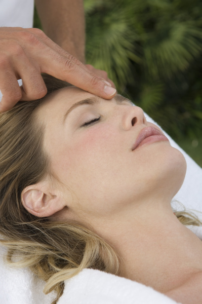 woman receiving a head massage at