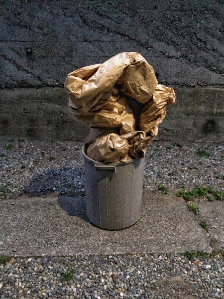 garbage crumpled up in trash can