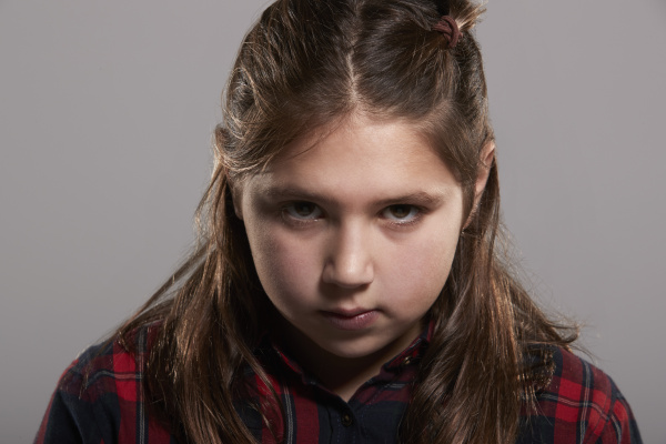 serious-ten-year-old-girl-looking-to-camera-head-and-stock-photo