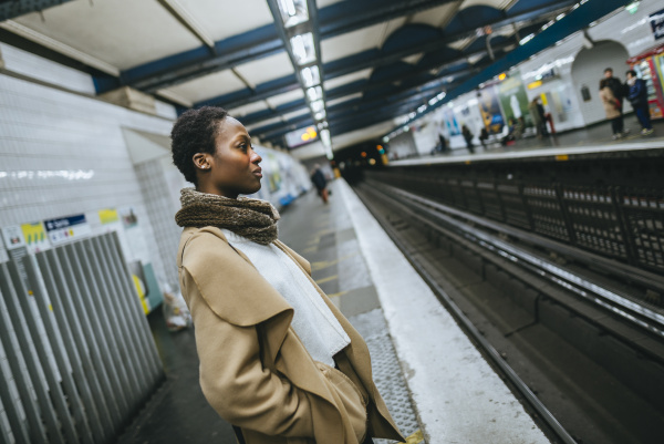 young woman waiting at subway station