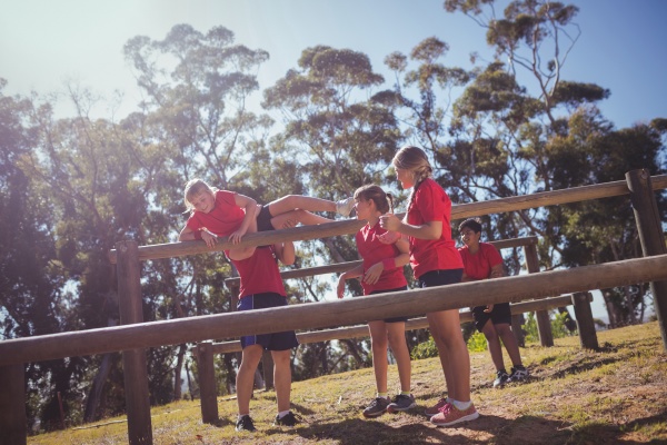 trainer-instructing-kids-during-obstacle-course-stock-photo-23148623