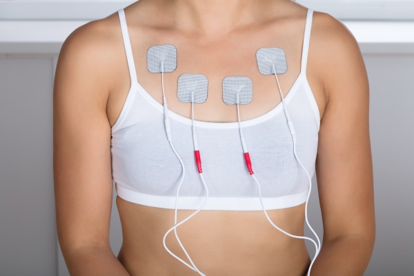 woman having electrotherapy on chest