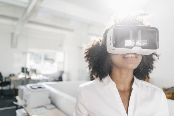 woman wearing vr glasses in office