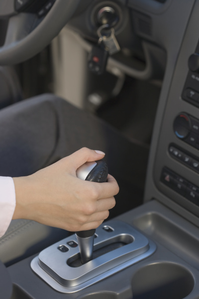 woman with hand on automatic gearshift