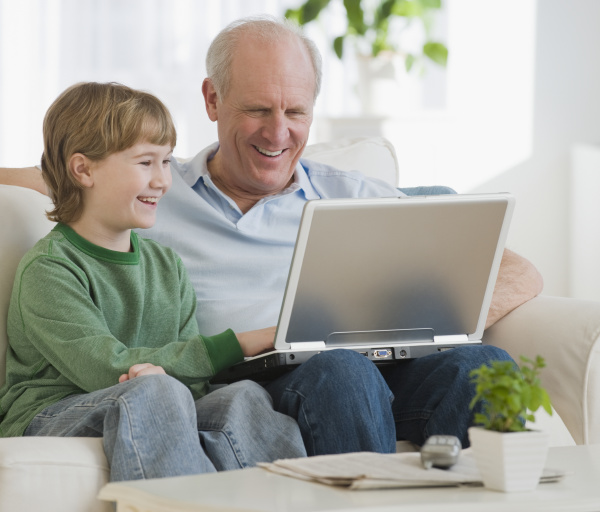 grandfather and grandson looking at laptop