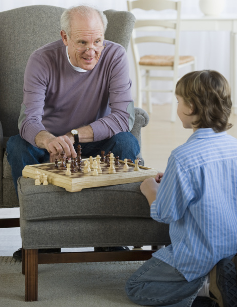 grandfather and grandson playing chess