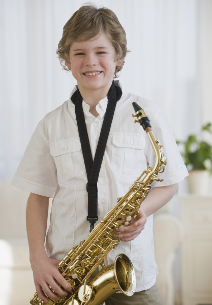 boy holding saxophone