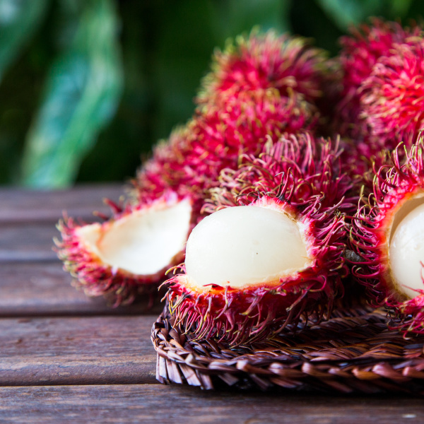 fresh ripe rambutans on wooden background