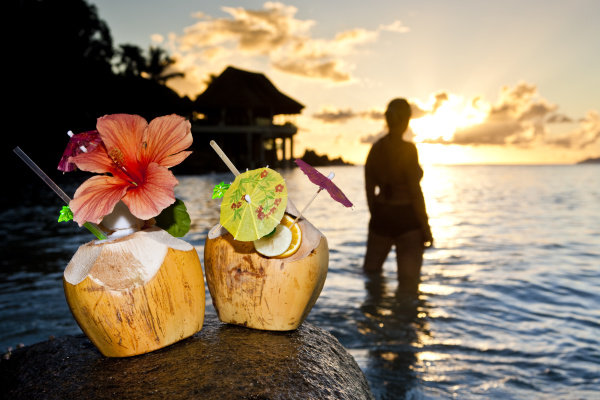 two coconuts with cocktails and decoration