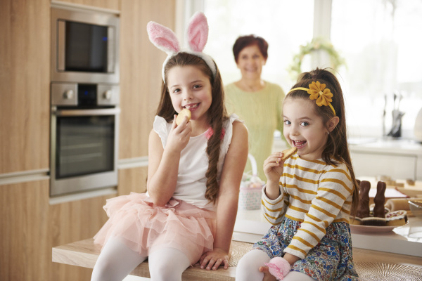 portrait of two smiling girls eating
