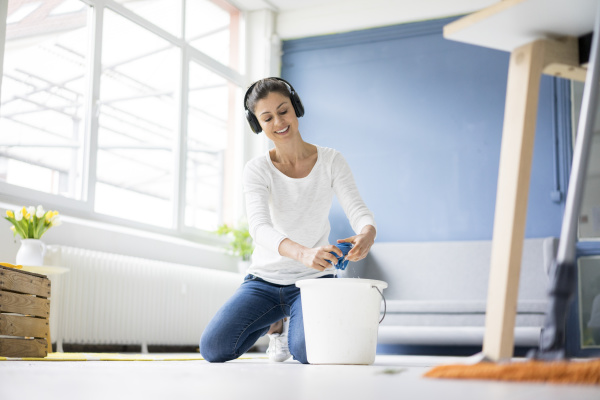smiling woman at home wearing headphones