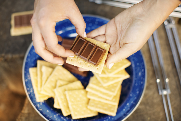 cropped image of hands preparing smores