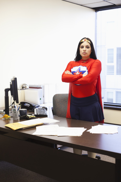 an hispanic businesswoman office super hero