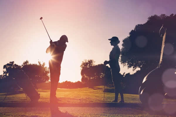 composite image of golfing couple playing