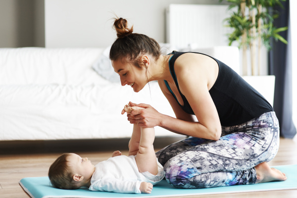 mother with baby exercising on yoga