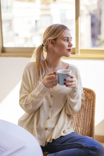 blonde woman with cup of coffee