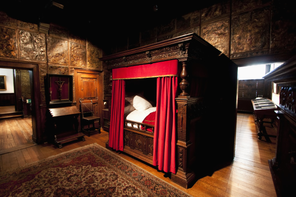 carved oak four poster bed in