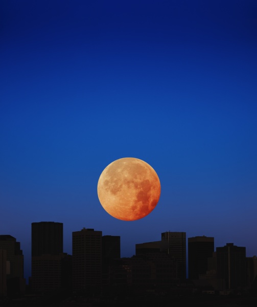 orange moon in dark sky