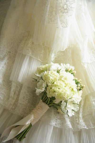 flower bouquet against wedding dress