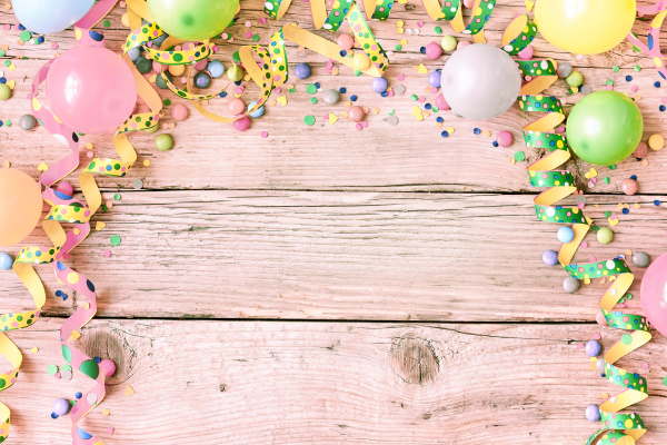 Brightly colored paper confetti background featuring red, yellow, blue,  green, orange, and bright pink carnival colors Stock Photo