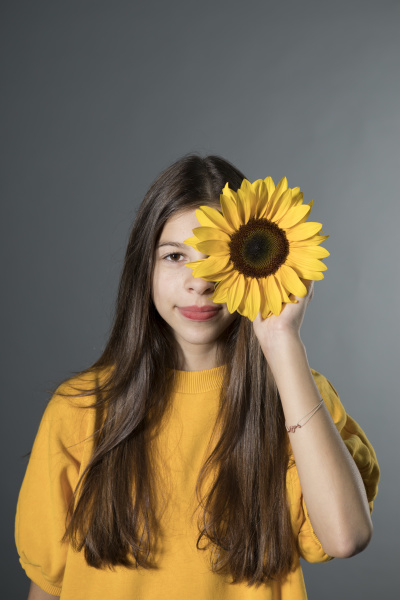 portrait of smiling girl with sunflower