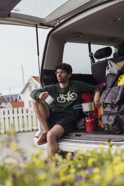 young man sitting in camper