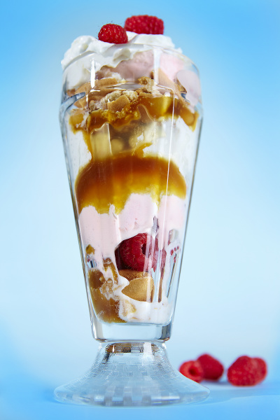 an ice cream sundae with raspberries