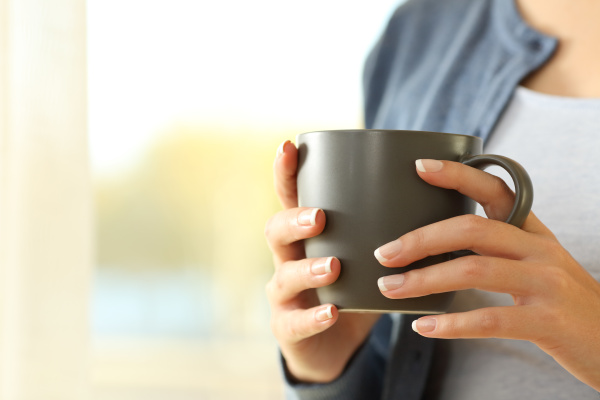 woman hands holding a coffee mug