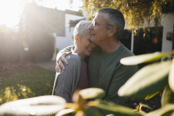 happy affectionate senior couple hugging in