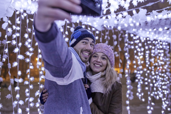 happy young couple in winter decoration