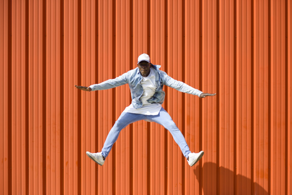 man wearing casual denim clothes jumping
