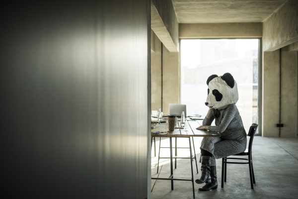 woman with panda mask sitting in