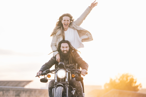 portrait of happy couple on motorbike