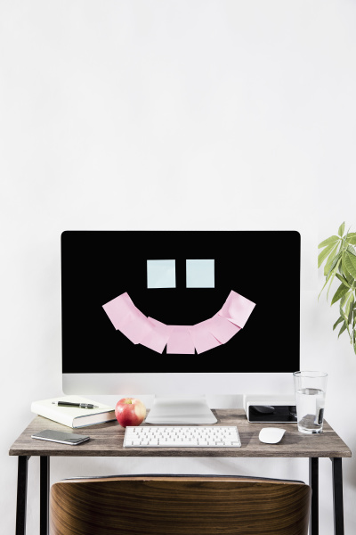 adhesive notes forming smiley face on