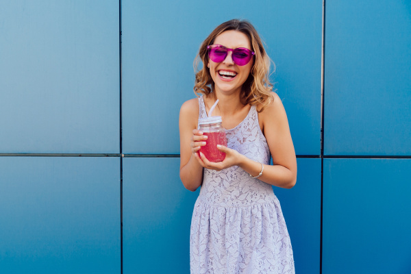 cheerful girl in sunglasses holds fruit
