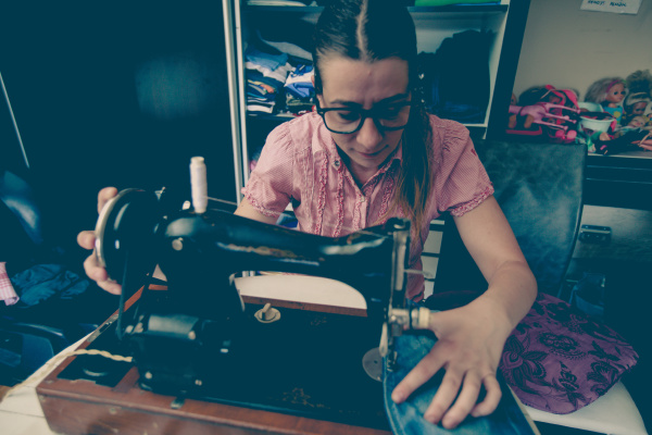 woman tailor using retro sewing machine