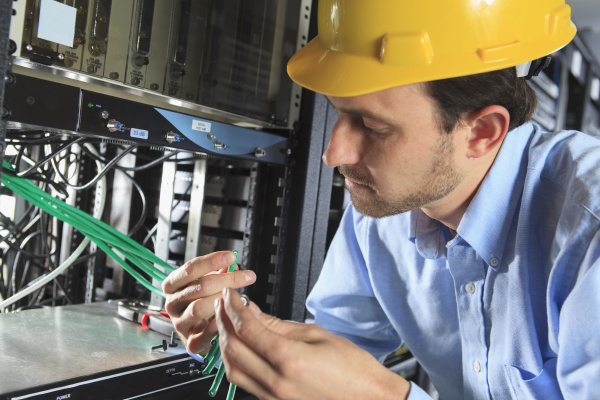 network engineer examining cable for termination
